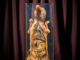 an image of a statue of an old man in a glass case