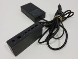 a picture of a black power strip and a charger on a white surface
