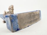 a small statue of a man sitting on a skateboard