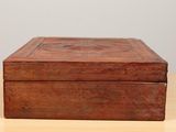 an old wooden box sitting on top of a wooden table