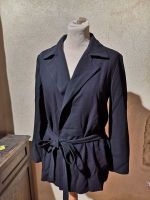 an image of a coat on a mannequin stand