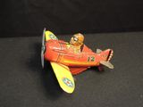 a small toy airplane with a pilot sitting on top of it