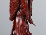 an image of a statue of a woman holding a sword on top of a wooden table