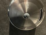 a stainless steel sink in a bathroom with a black tile floor
