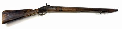 an old gun with a wooden barrel on a white background