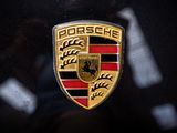 a close up of a porsche emblem on a car ' s hood