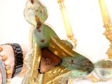 a figurine of a woman sitting on a bed
