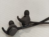 a pair of headphones laying on top of a bed