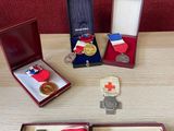 several medals and medals are sitting on a wooden table