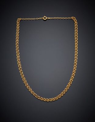 a gold chain necklace on a black background