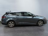 the grey car is parked in a large room with a white wall