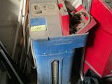 a red trash can and a blue trash can in a garage