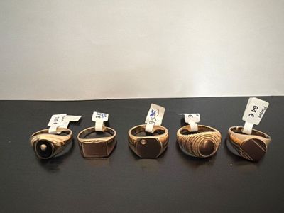 four different types of wooden rings on display on a table