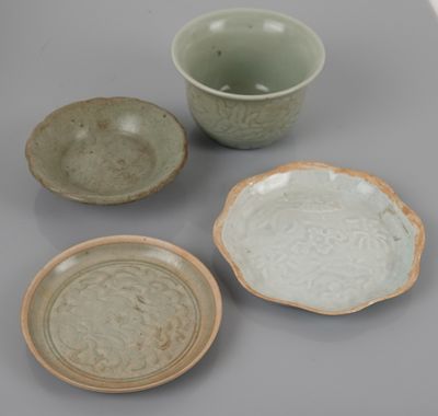 three bowls and a bowl sitting on top of a table