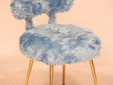 a blue chair with a fuzzy seat and legs