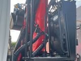 a picture of a red and black truck with a crane on it ' s back