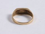 a close up of a gold ring on a white surface