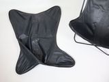 pair of black leather butterfly chairs sitting on a white surface