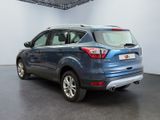the rear end of a blue ford escape parked in a garage