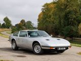 a silver sports car parked on the side of the road