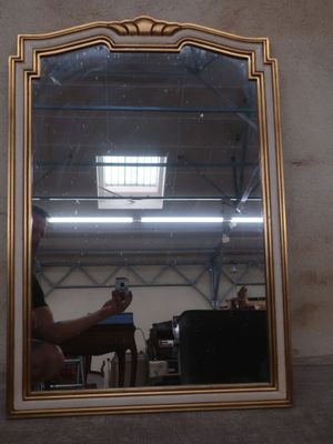 a man sitting in a chair in front of a mirror