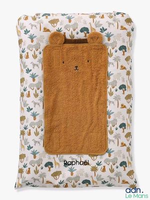 a brown towel sitting on top of a pillow covered in animal print