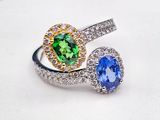 an image of two rings with different colored stones on a white plate