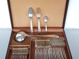 a box with silverware inside of it on a table