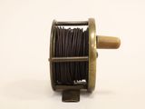 a spool with a spool on it on a white surface