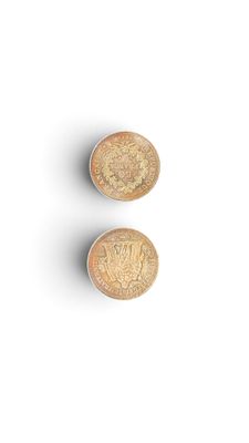 two wooden buttons on a white surface with a white background