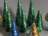 a lot of different colored christmas trees that are on a table