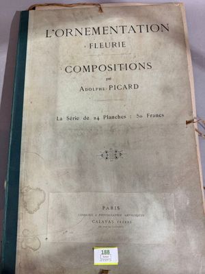 an old book sitting on top of a table next to a glass