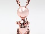a pink rabbit figurine sitting on top of a white surface
