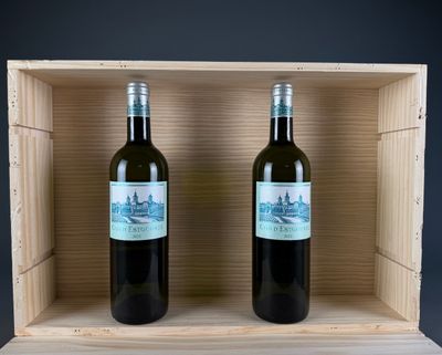 two bottles of wine in a wooden box on a table