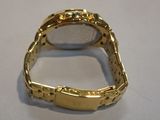 an image of a close up of a gold watch on a table