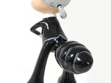 a figurine of a woman with a camera on a white background