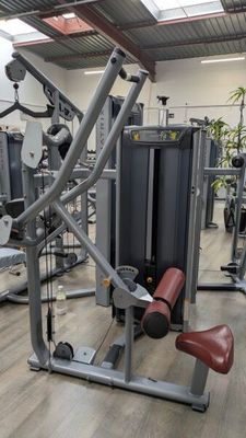 a gym room with a variety of machines in it