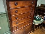 a wooden dresser with many drawers in a room