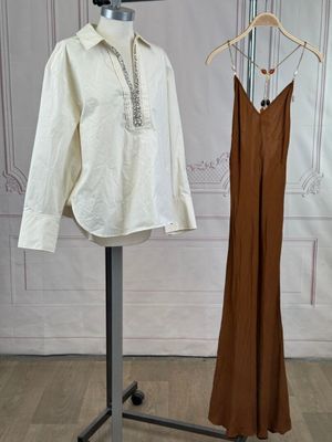 a mannequin and a dress on a stand in a room