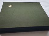 a stack of green books on a white surface