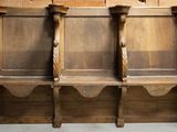 three wooden benches sitting next to each other in a room
