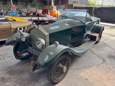 a green car parked in a parking lot with other cars in the background