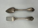 two spoons and a fork sitting on a table