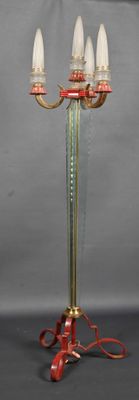 a lamp that is on a stand with a red cord