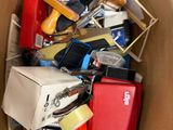 a cardboard box filled with assorted electronic devices