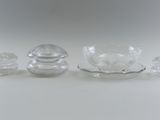 three glass objects sitting on a white surface