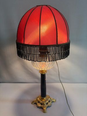 an image of a lamp with a red shade on top of it