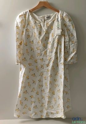 the shirt is hanging on a hanger on the wall