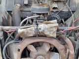an old car engine sitting in the back of a truck