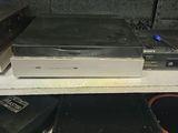 several electronic equipment are stacked on top of each other on a shelf